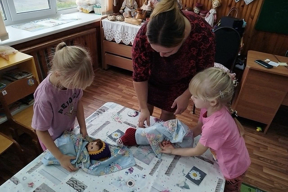 Дошкольницы укутывают кукол